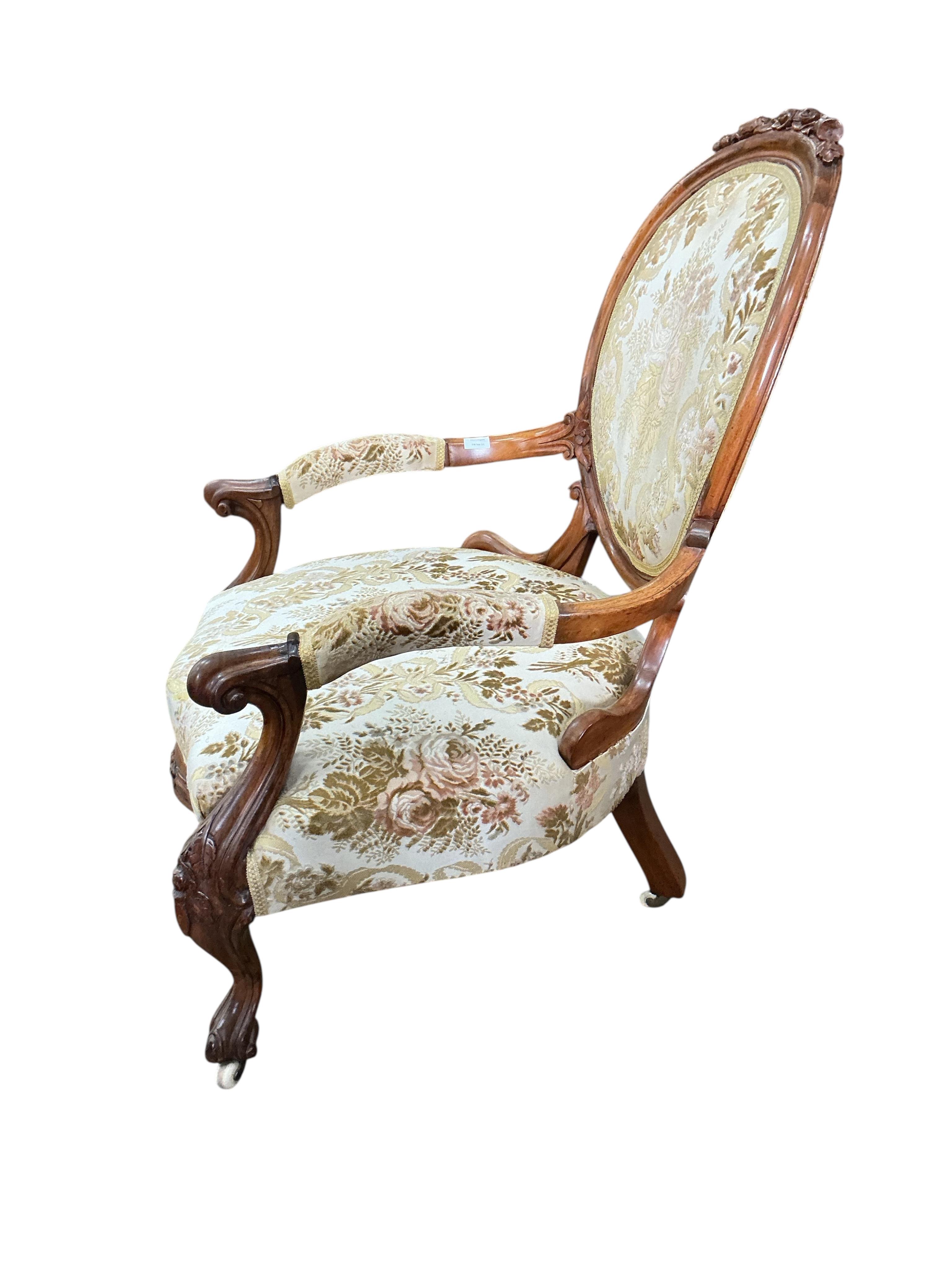 A Victorian faded rosewood spoon back open armchair, width 70cm, depth 62cm, height 100cm
